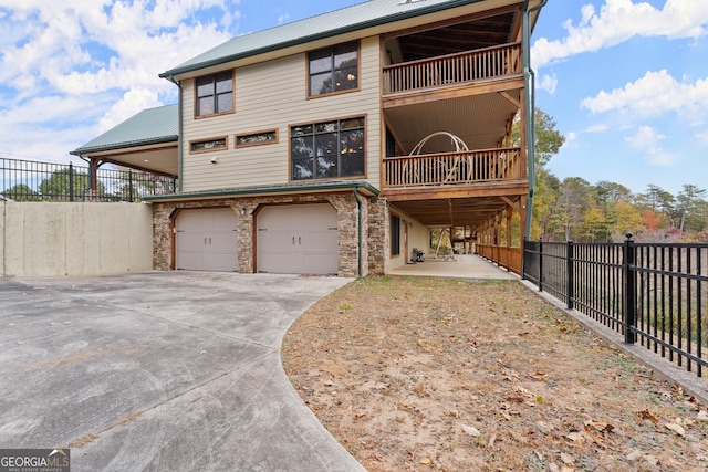 view of front facade with a garage and a patio