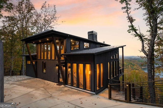 view of back house at dusk