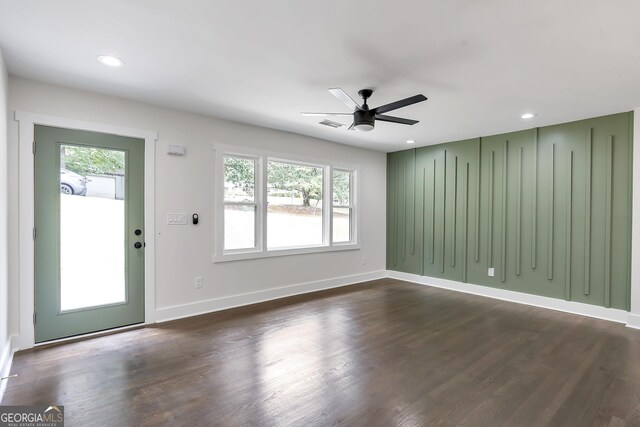 interior space with plenty of natural light, ceiling fan, and dark hardwood / wood-style flooring