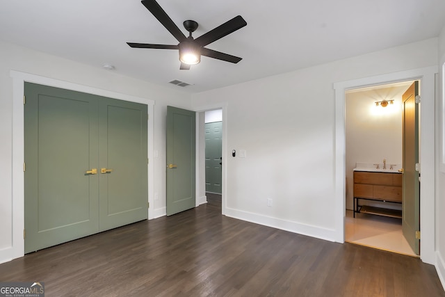 unfurnished bedroom featuring ceiling fan and dark hardwood / wood-style floors