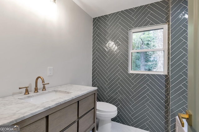 bathroom with tile patterned floors, vanity, and toilet