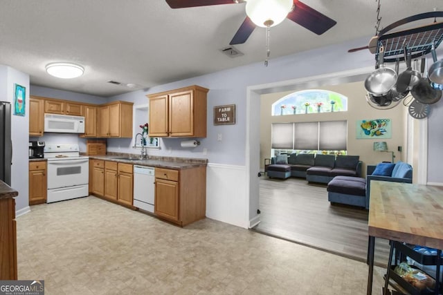 kitchen featuring sink, a textured ceiling, white appliances, and ceiling fan