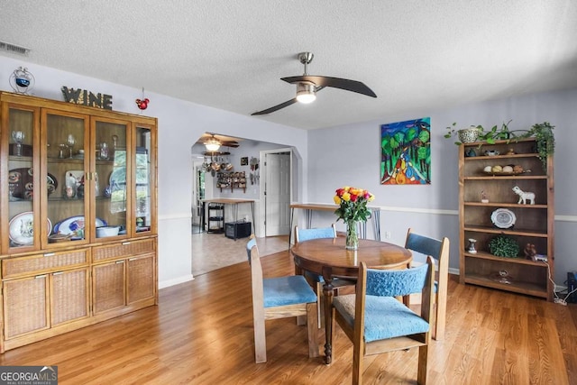 dining room with hardwood / wood-style floors and a textured ceiling