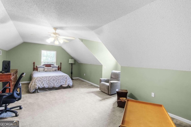 bedroom with a textured ceiling, vaulted ceiling, carpet floors, and ceiling fan