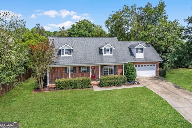 new england style home featuring a front yard and a garage