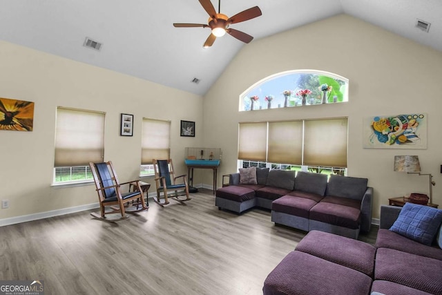 living room featuring high vaulted ceiling, wood-type flooring, and ceiling fan