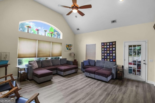 living room featuring hardwood / wood-style floors, high vaulted ceiling, and ceiling fan