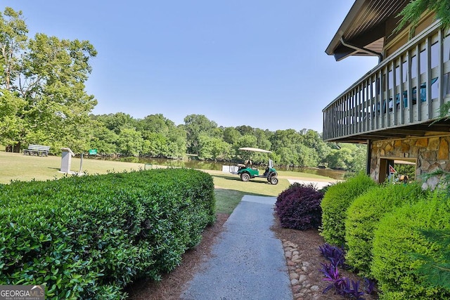 rear view of property featuring a yard and a sunroom