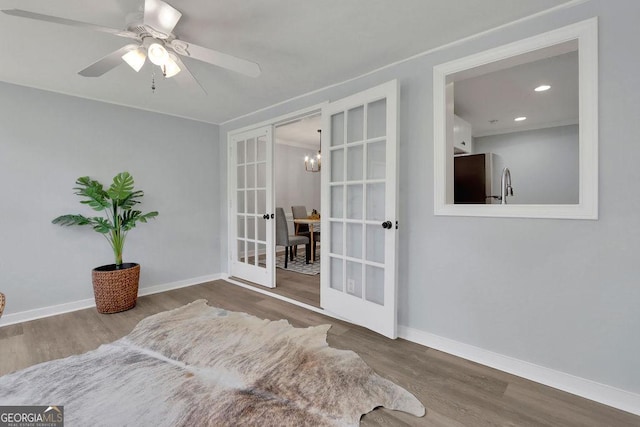 living area with ceiling fan, hardwood / wood-style floors, and french doors