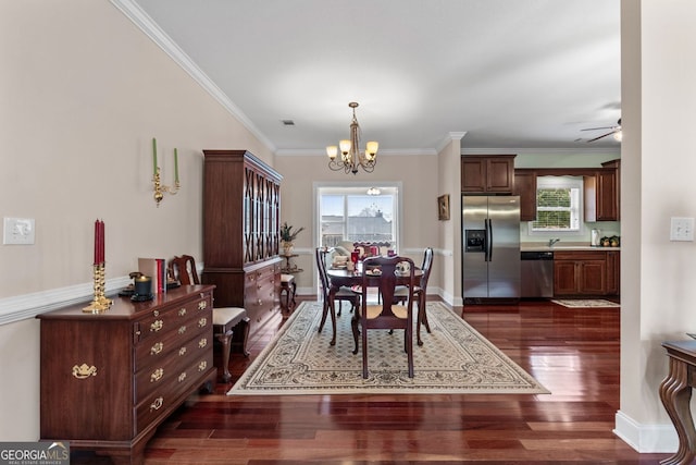 dining room with ornamental molding, a wealth of natural light, and dark wood-style flooring