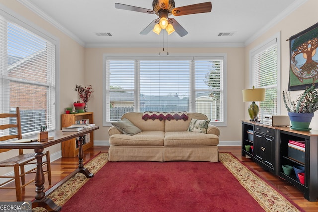 sitting room with crown molding and plenty of natural light