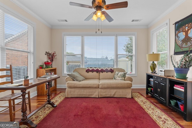 living room with plenty of natural light, wood finished floors, and crown molding