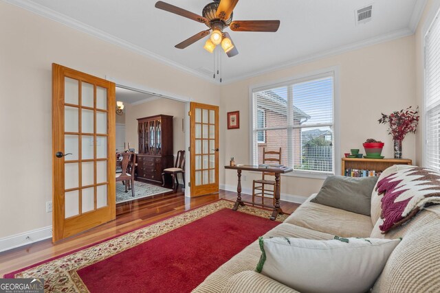 living room with french doors, hardwood / wood-style floors, and ornamental molding