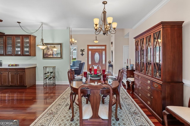 dining room featuring an inviting chandelier, baseboards, dark wood-style floors, and crown molding