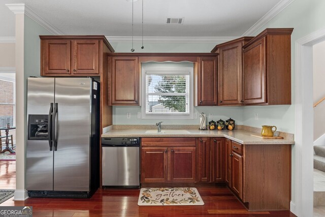 kitchen with ornamental molding, stainless steel appliances, sink, and dark hardwood / wood-style flooring