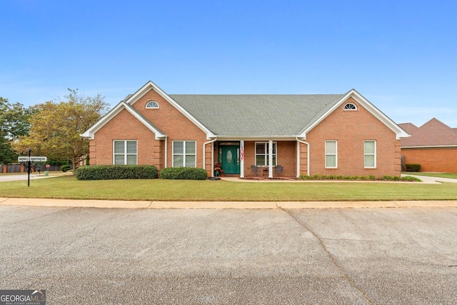 view of front of property with a front yard and brick siding