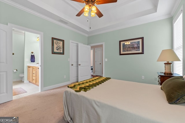 bedroom with light colored carpet, a raised ceiling, multiple windows, and visible vents