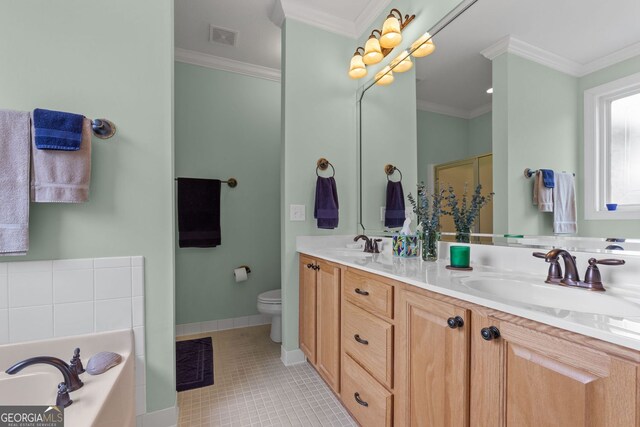 bathroom featuring crown molding, a washtub, vanity, and toilet