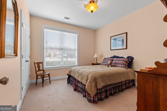 bedroom featuring light colored carpet