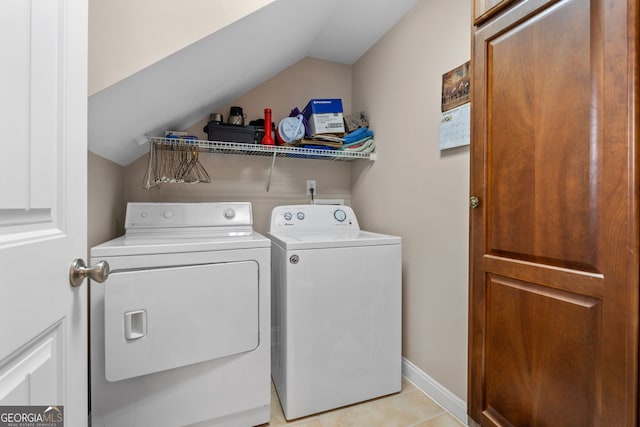 laundry room with light tile patterned flooring and washer and dryer