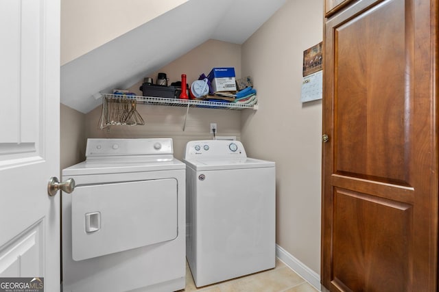 washroom featuring laundry area, washer and clothes dryer, and baseboards