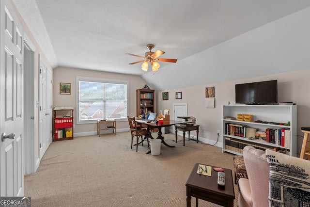 interior space featuring carpet floors, lofted ceiling, ceiling fan, and baseboards