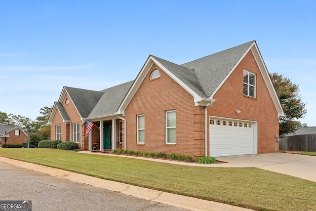 traditional-style home featuring an attached garage, brick siding, a shingled roof, driveway, and a front yard