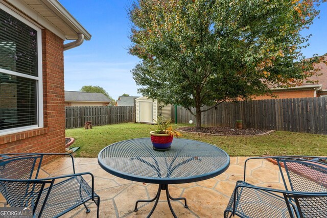 view of patio with a storage unit