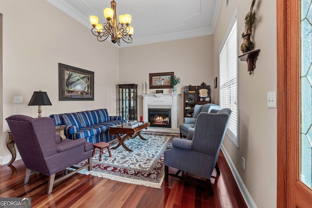 living area with a warm lit fireplace, ornamental molding, and wood finished floors