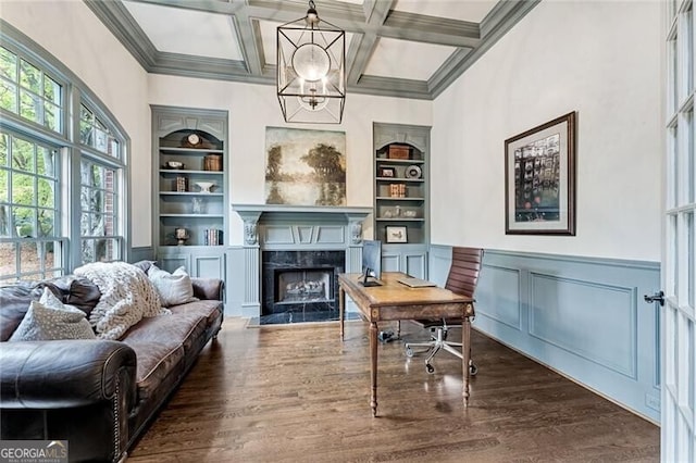 living area with built in shelves, a high end fireplace, dark hardwood / wood-style floors, and coffered ceiling