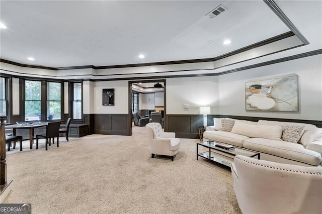 carpeted living room featuring ornamental molding