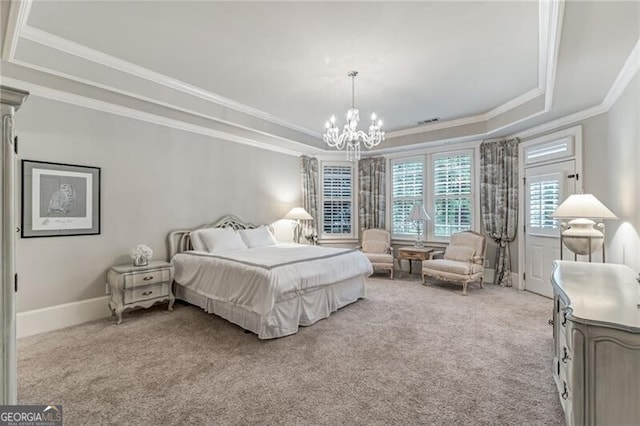 carpeted bedroom with ornamental molding, a notable chandelier, and a tray ceiling