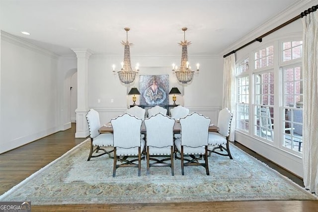 dining room featuring ornamental molding, dark hardwood / wood-style flooring, and decorative columns