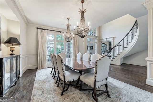 dining room with ornamental molding, dark hardwood / wood-style floors, and decorative columns