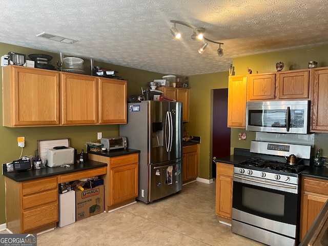 kitchen featuring a textured ceiling and stainless steel appliances