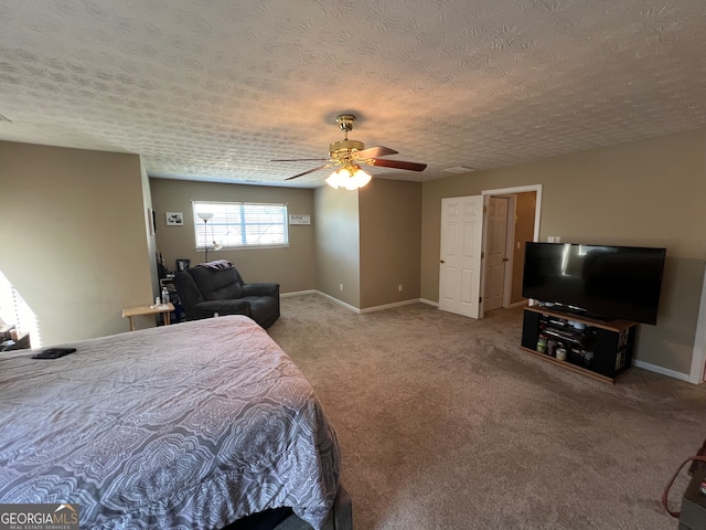 bedroom featuring carpet, a textured ceiling, and ceiling fan