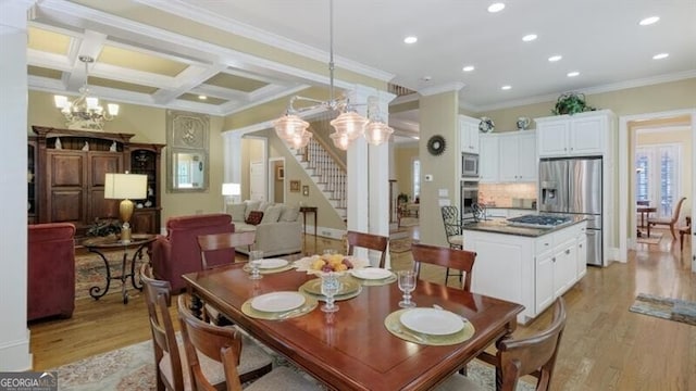 dining area with an inviting chandelier, light wood-type flooring, ornamental molding, beamed ceiling, and coffered ceiling