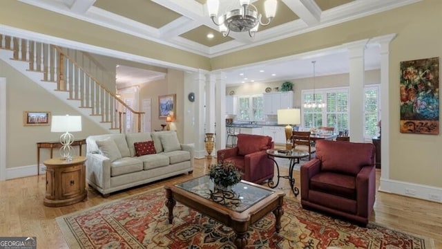 living room with an inviting chandelier, light wood-type flooring, ornamental molding, beamed ceiling, and coffered ceiling