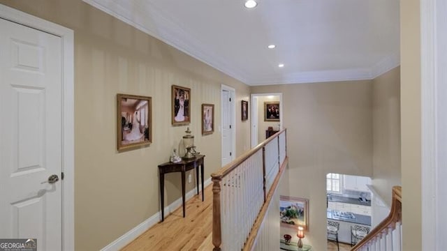 hall featuring ornamental molding and light hardwood / wood-style floors