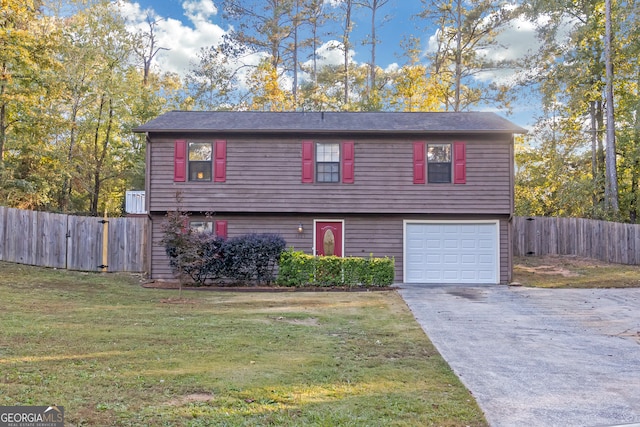 view of front of home with a front lawn and a garage