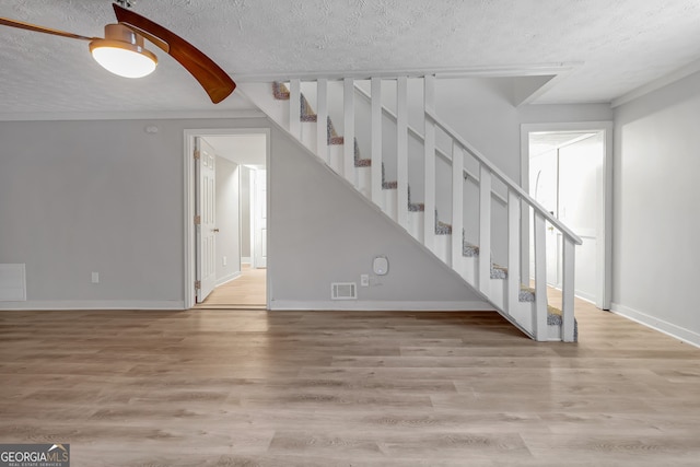 interior space with a textured ceiling and hardwood / wood-style flooring