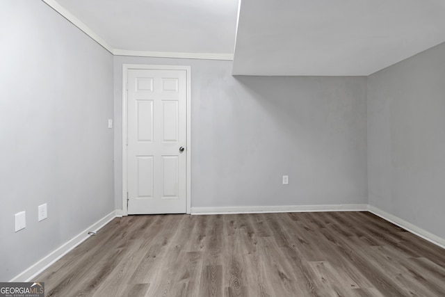 interior space featuring ornamental molding and light wood-type flooring