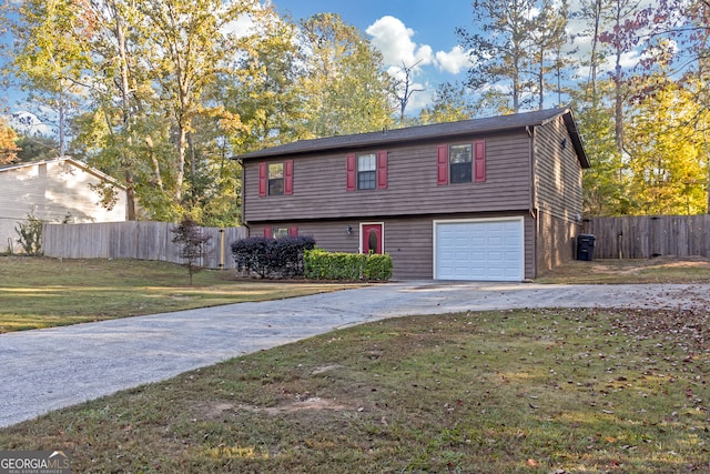 view of front of home with a garage and a front lawn