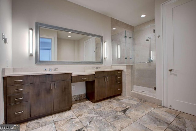 bathroom with vanity and a shower with door