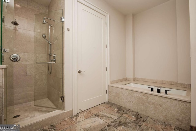 bathroom featuring separate shower and tub