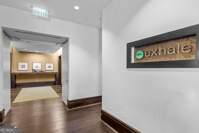 corridor with dark hardwood / wood-style floors