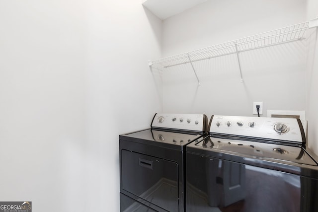 clothes washing area featuring washing machine and dryer