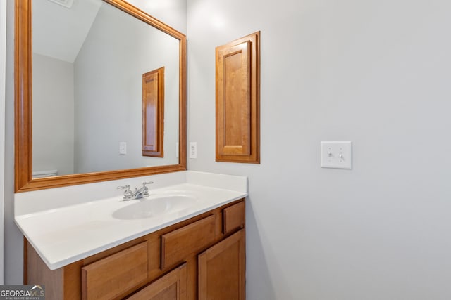 bathroom featuring vanity and vaulted ceiling