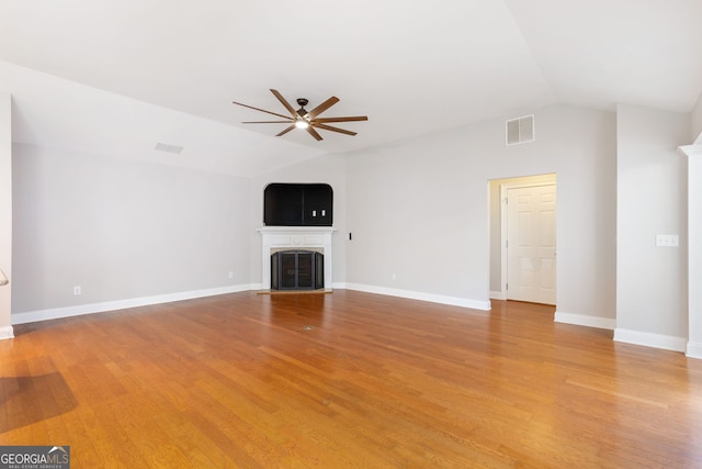 unfurnished living room with lofted ceiling, ceiling fan, and light hardwood / wood-style flooring