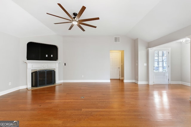 unfurnished living room featuring hardwood / wood-style floors, ceiling fan, and lofted ceiling